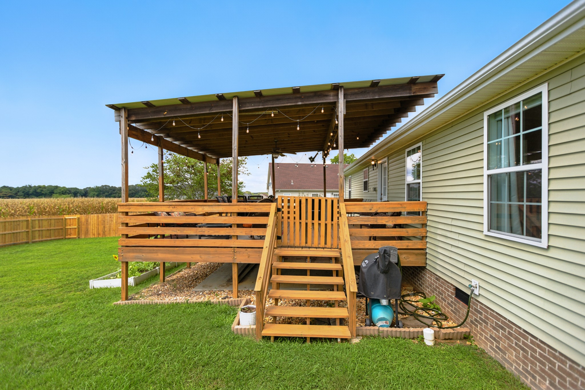 6411 Spring Creek Road Tullahoma, TN 37388 - Photo 46 of 57 a view of a patio with table and chairs with wooden floor and fence