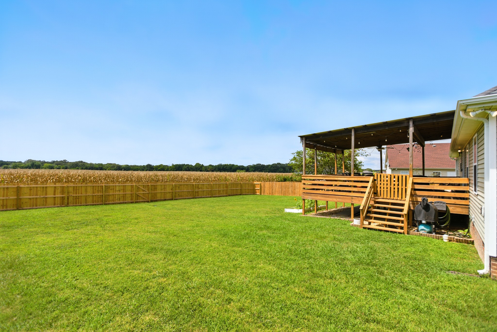 6411 Spring Creek Road Tullahoma, TN 37388 - Photo 48 of 57 a backyard of a house with lots of green space and bench