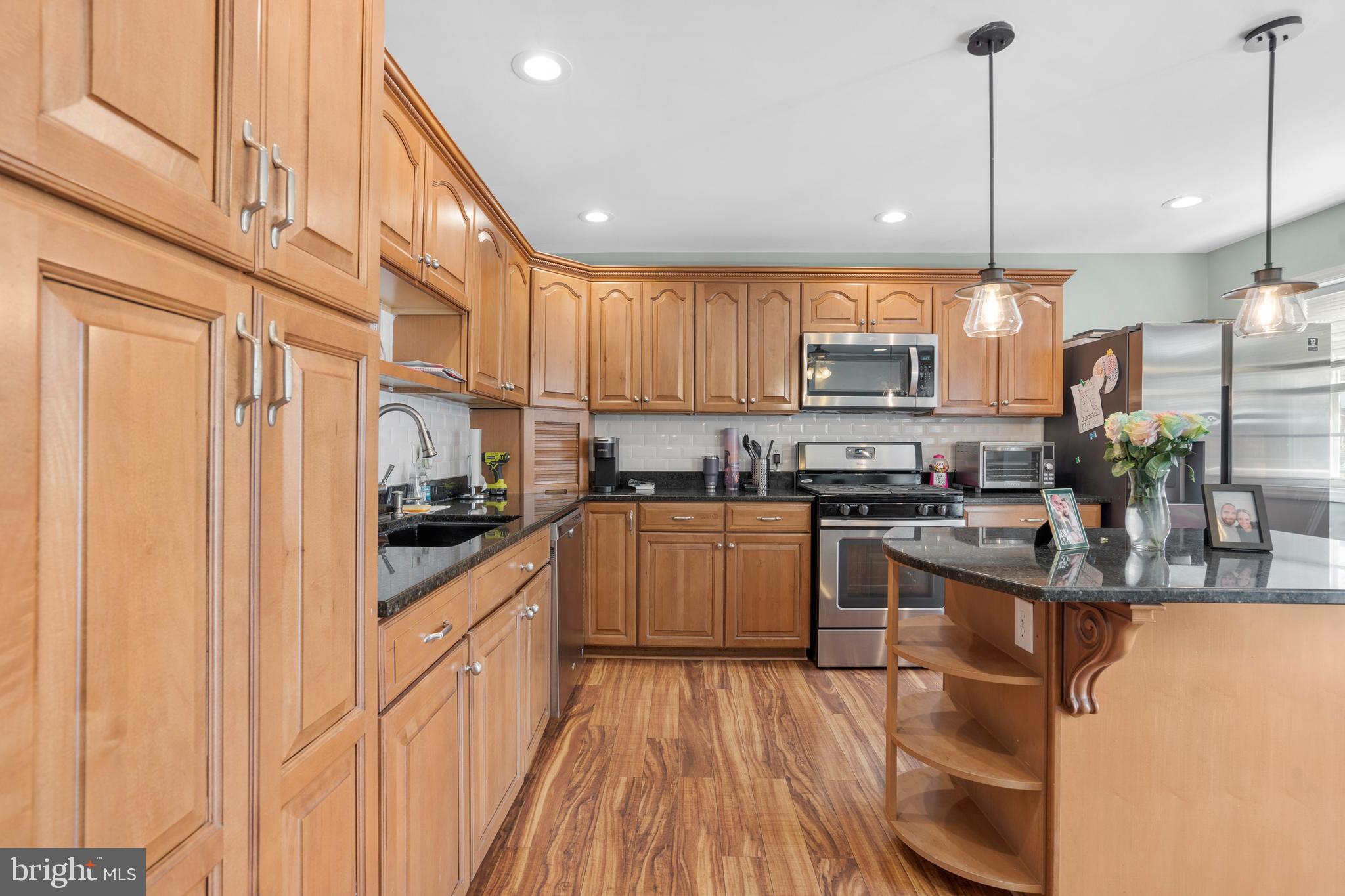 12413 Dunks Ferry Road Philadelphia, PA 19154 - Photo 11 of 35 a kitchen with stainless steel appliances granite countertop a sink a stove and a wooden floors