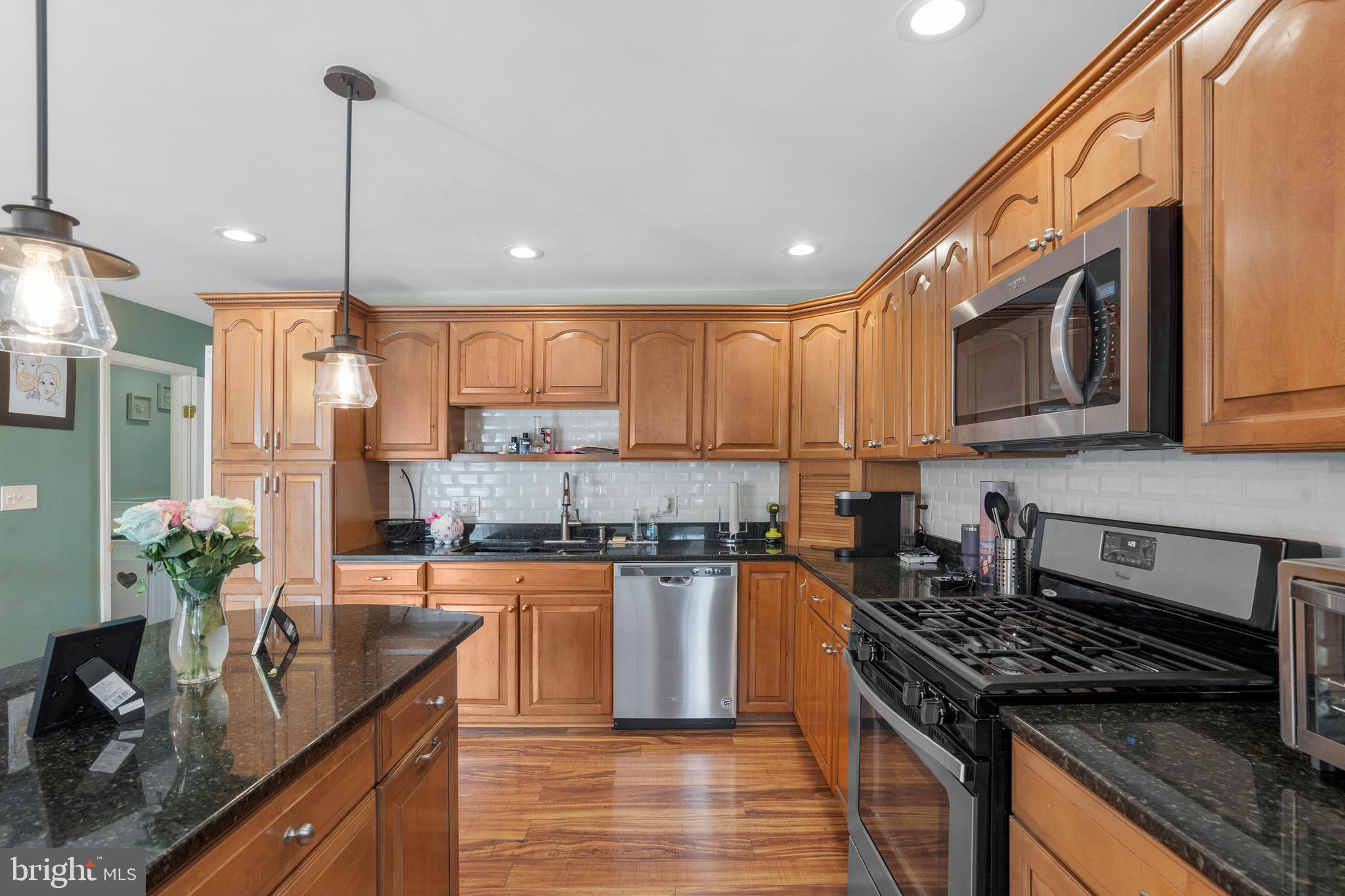 12413 Dunks Ferry Road Philadelphia, PA 19154 - Photo 14 of 35 a kitchen with stainless steel appliances granite countertop a sink a stove and a wooden floors