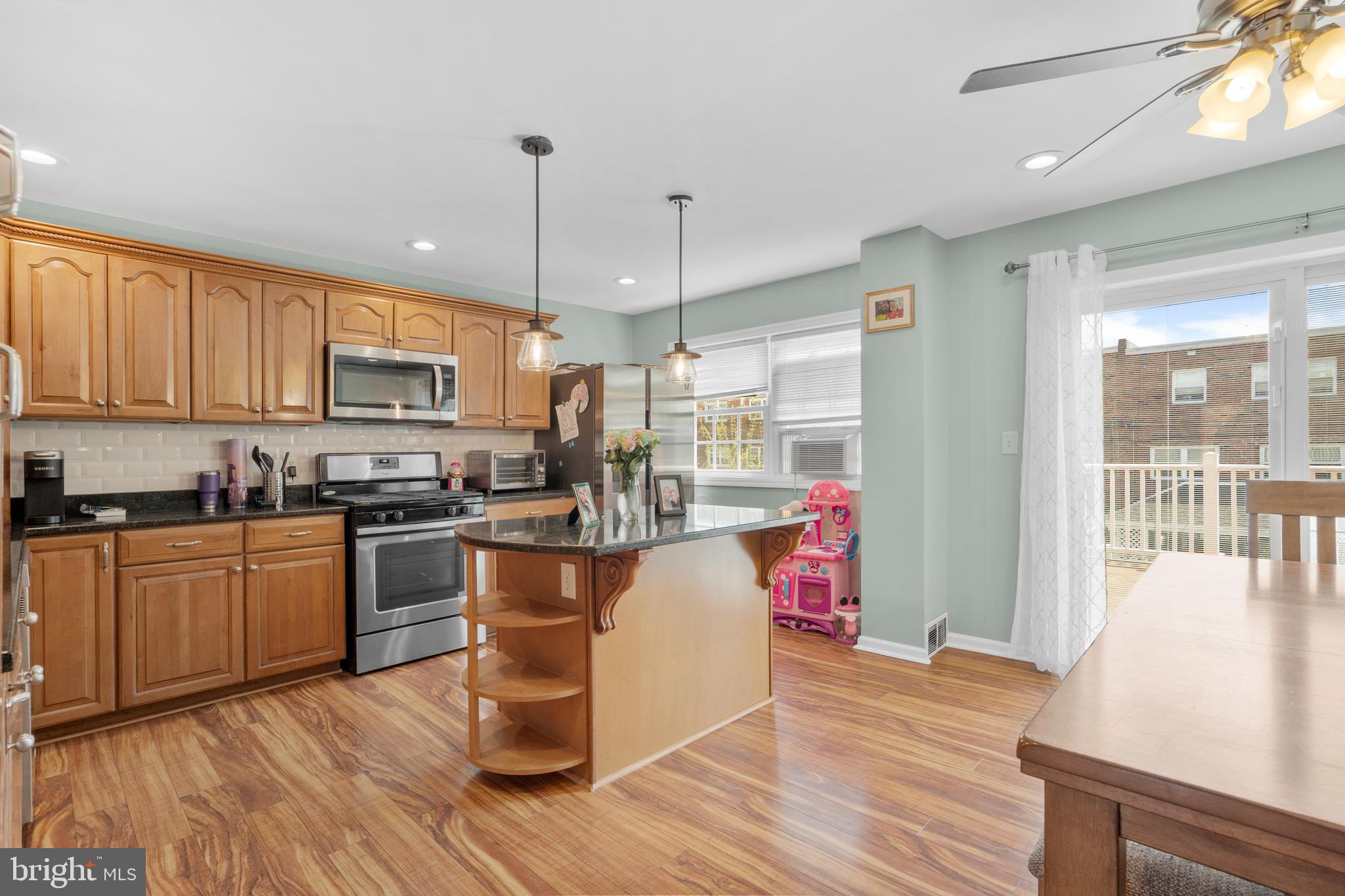 12413 Dunks Ferry Road Philadelphia, PA 19154 - Photo 10 of 35 a kitchen with a refrigerator a stove top oven a sink dishwasher and white cabinets with wooden floor