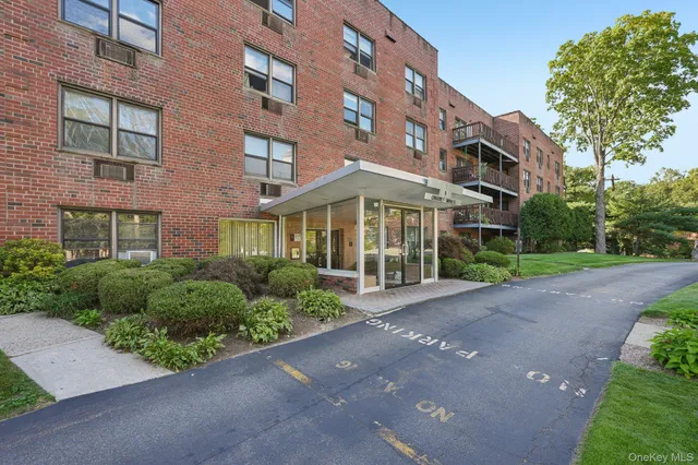 a view of a brick building next to a yard