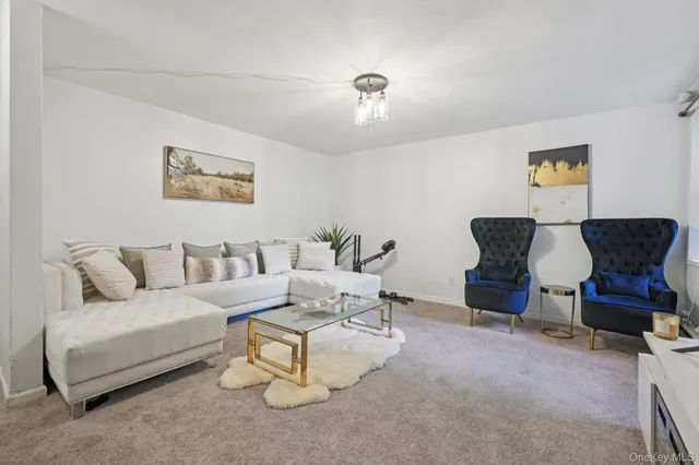 a living room with furniture and a painting