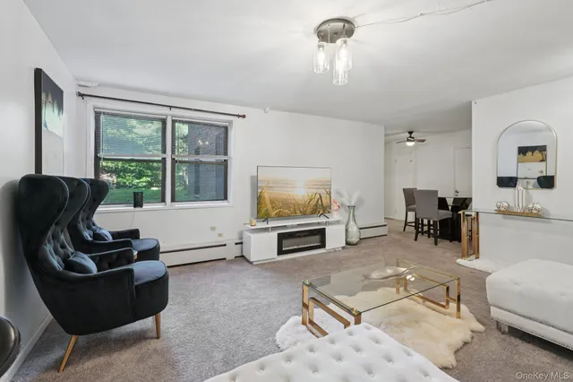 a living room with furniture large window and a flat screen tv