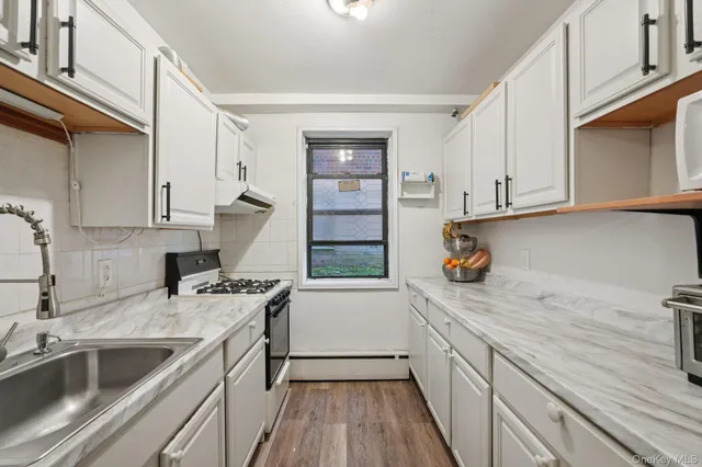 a kitchen with a sink stove and cabinets