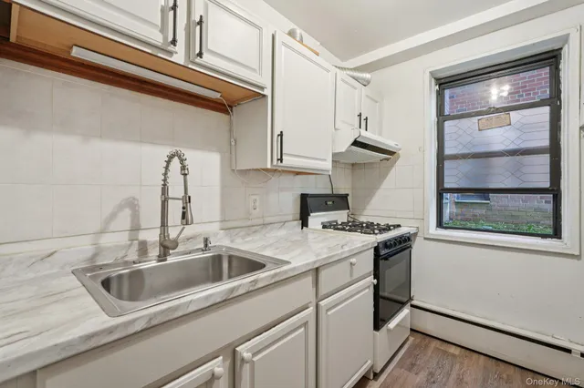 a kitchen that has a sink and a stove