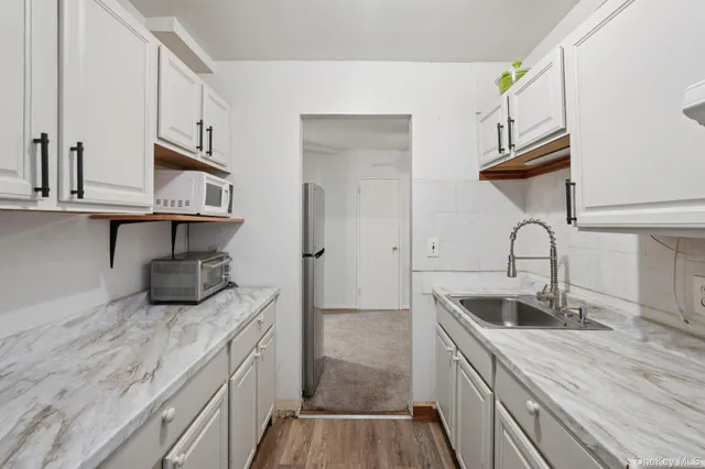 a kitchen with sink and cabinets