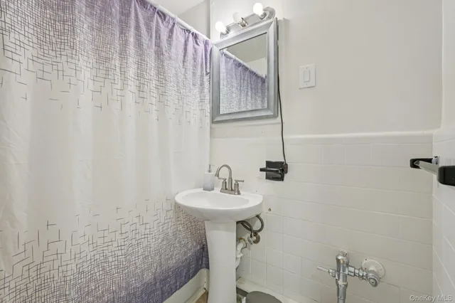a bathroom with a sink a mirror and a shower