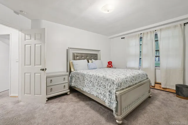 a bedroom with bed and a window