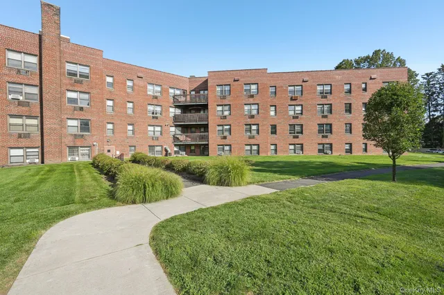 a view of a building with a yard