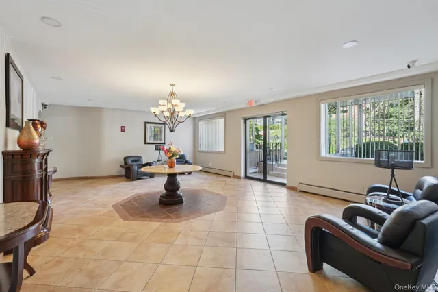 a living room with furniture and a chandelier
