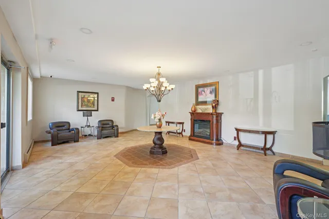 a living room with fireplace furniture and a chandelier