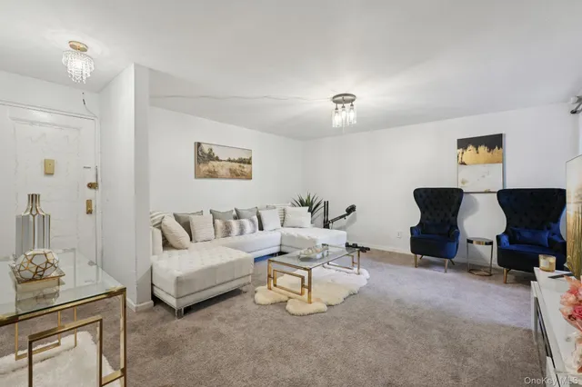 a living room with furniture and a lamp