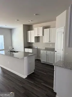 a kitchen with a sink cabinets and window