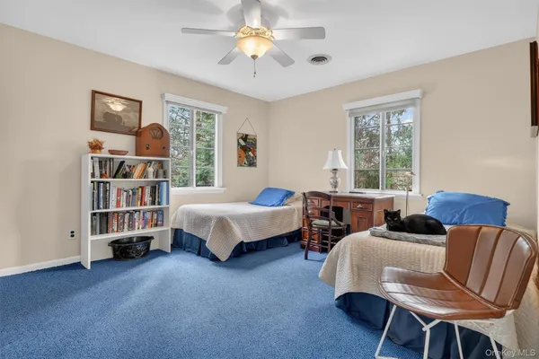a living room with furniture a flat screen tv and gym equipment