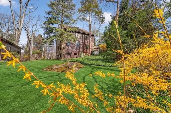 an aerial view of a house with a yard and lake view