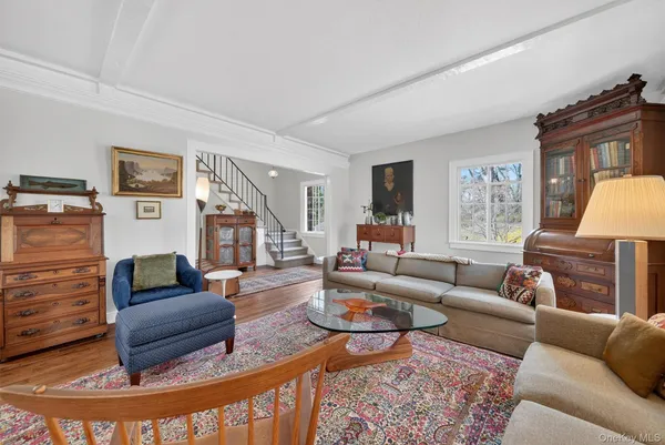 a living room with fireplace furniture and a rug