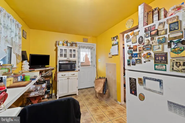 a view of a livingroom with workspace and a couch