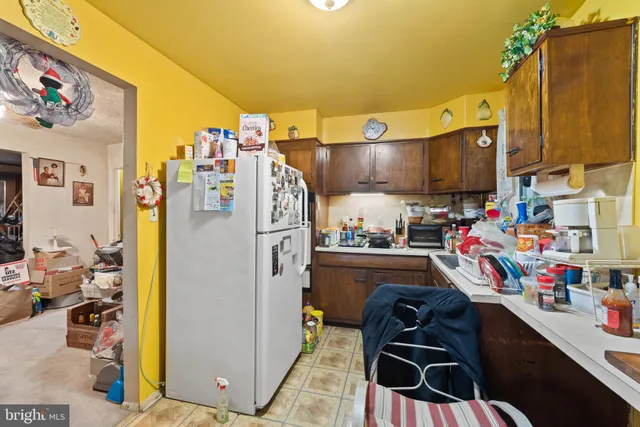 a kitchen with refrigerator and cabinets