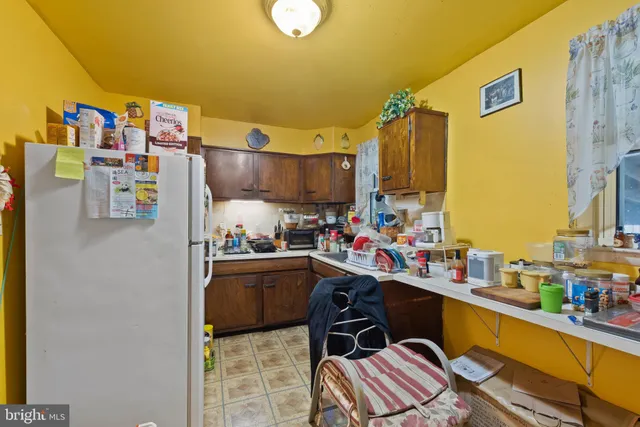 a kitchen filled with a refrigerator and a sink