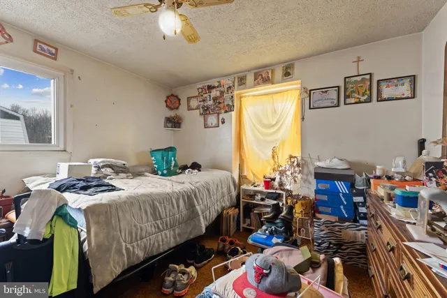 a bedroom that has a bed and a chandelier