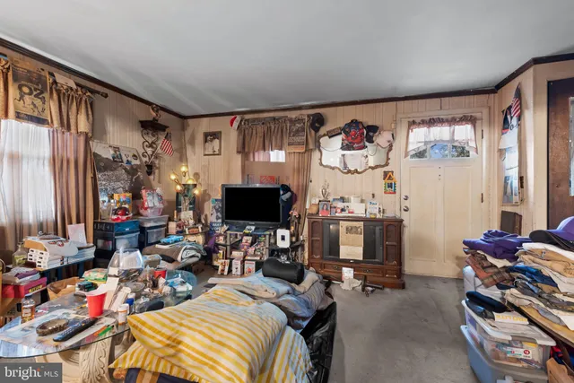 a bedroom with furniture and a flat screen tv