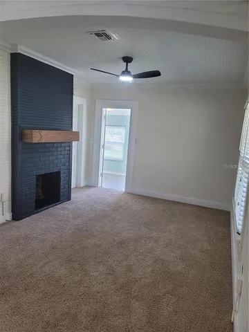 a view of empty room with a fireplace