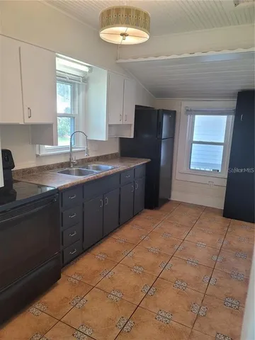 a kitchen with stainless steel appliances granite countertop a sink and cabinets
