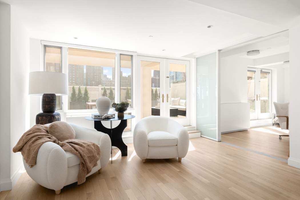 435 East 76th Street, Unit PHB Manhattan, NY 10021 - Photo 10 of 28 a living room with furniture and a large window