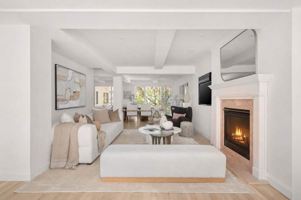 435 East 76th Street, Unit PHB Manhattan, NY 10021 - Photo 16 of 28 a living room with furniture a fireplace and a flat screen tv
