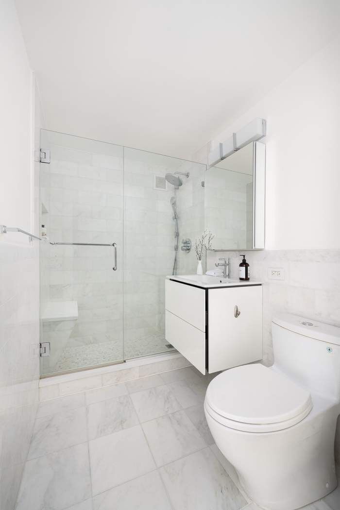 435 East 76th Street, Unit PHB Manhattan, NY 10021 - Photo 22 of 28 a bathroom with a sink a toilet and shower