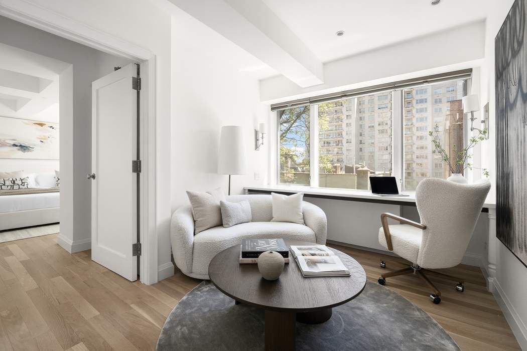 435 East 76th Street, Unit PHB Manhattan, NY 10021 - Photo 23 of 28 a living room with furniture and a large window