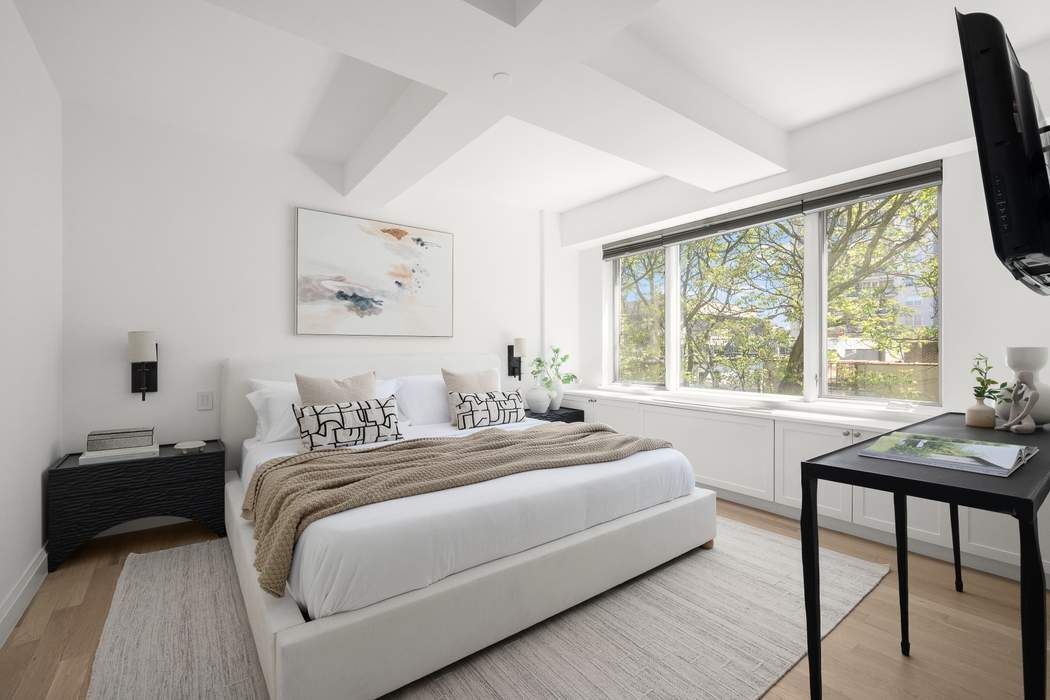 435 East 76th Street, Unit PHB Manhattan, NY 10021 - Photo 24 of 28 a bedroom with a bed and a large window