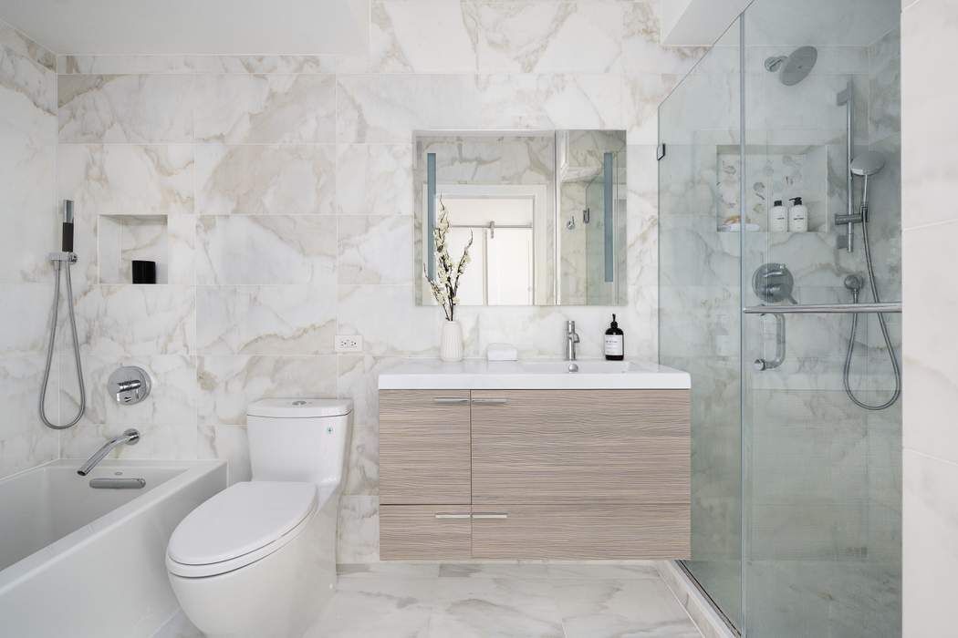 435 East 76th Street, Unit PHB Manhattan, NY 10021 - Photo 25 of 28 a bathroom with a granite countertop sink toilet and shower