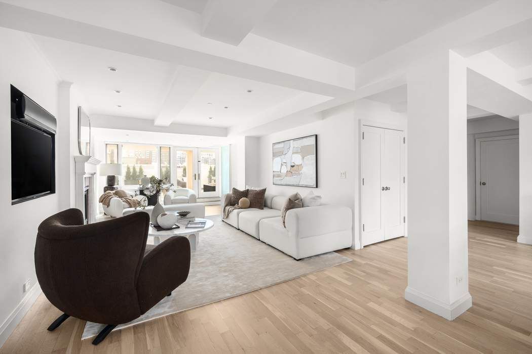 435 East 76th Street, Unit PHB Manhattan, NY 10021 - Photo 2 of 28 a living room with fireplace furniture and a flat screen tv