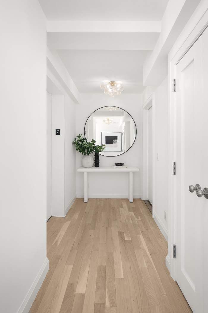 435 East 76th Street, Unit PHB Manhattan, NY 10021 - Photo 5 of 28 a view of a bedroom with wooden floor and window