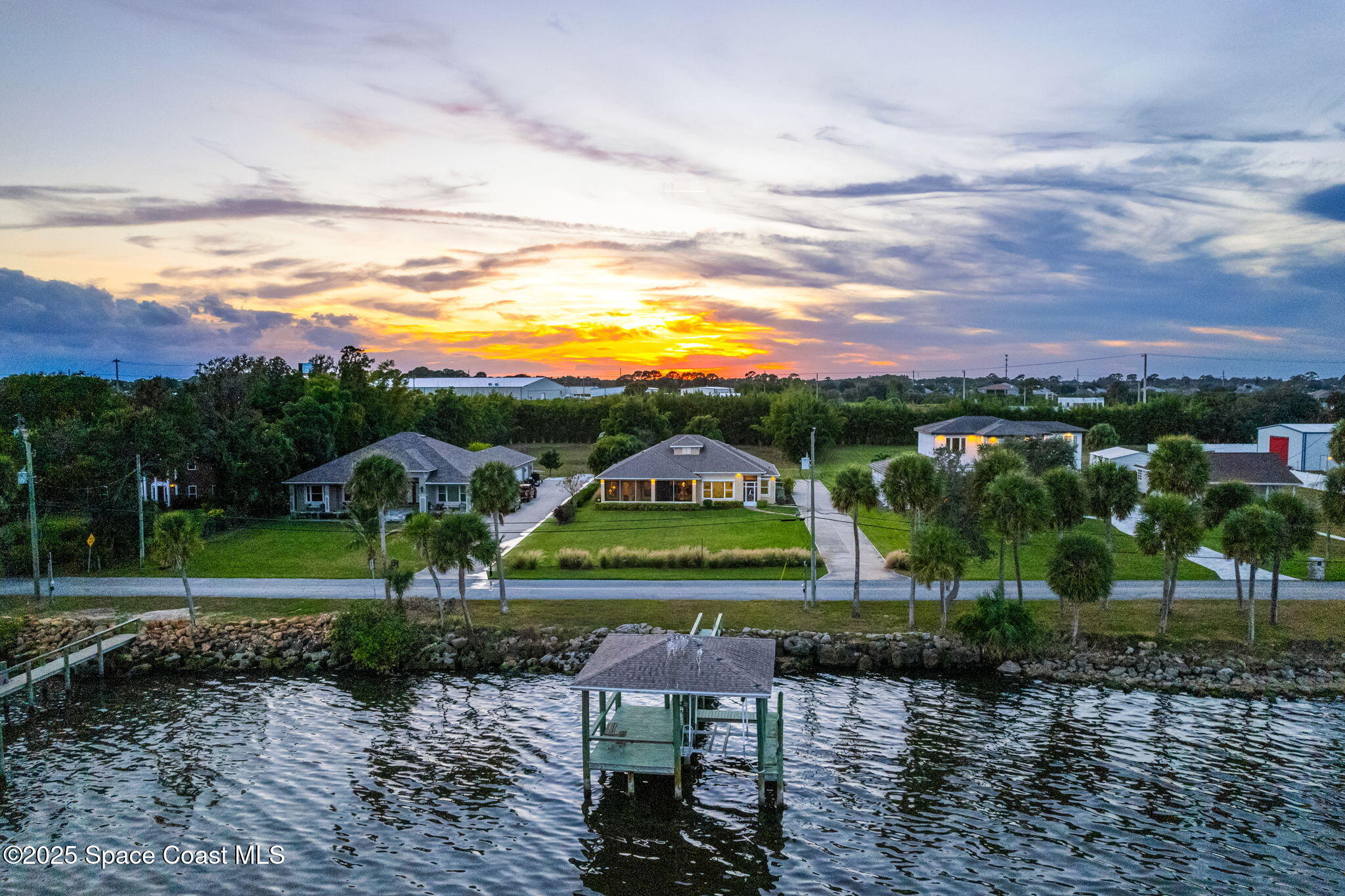a view of a lake with houses in the back