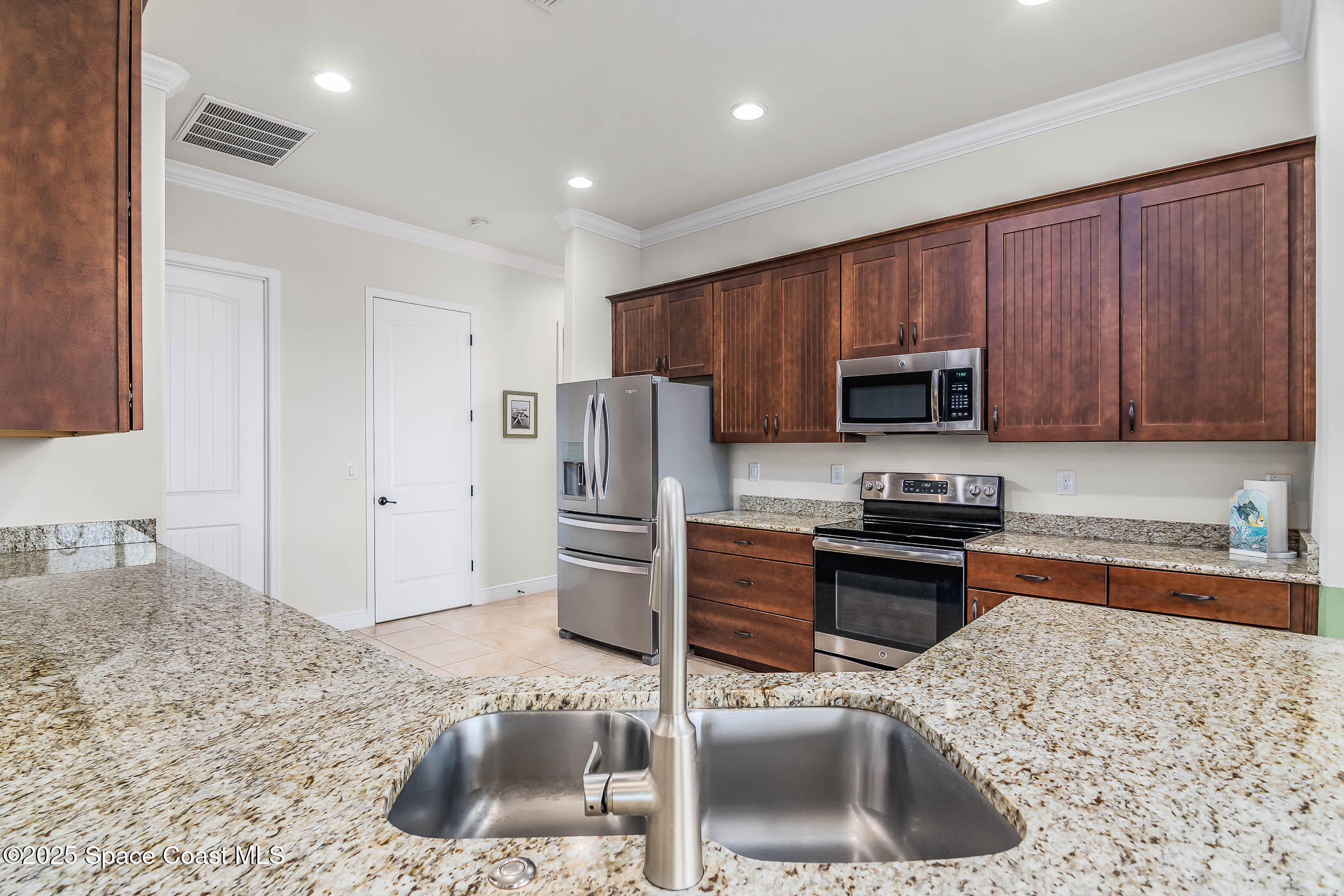 1953 Rockledge Drive Rockledge, FL 32955 - Photo 15 of 83 a kitchen with stainless steel appliances granite countertop a sink refrigerator and microwave