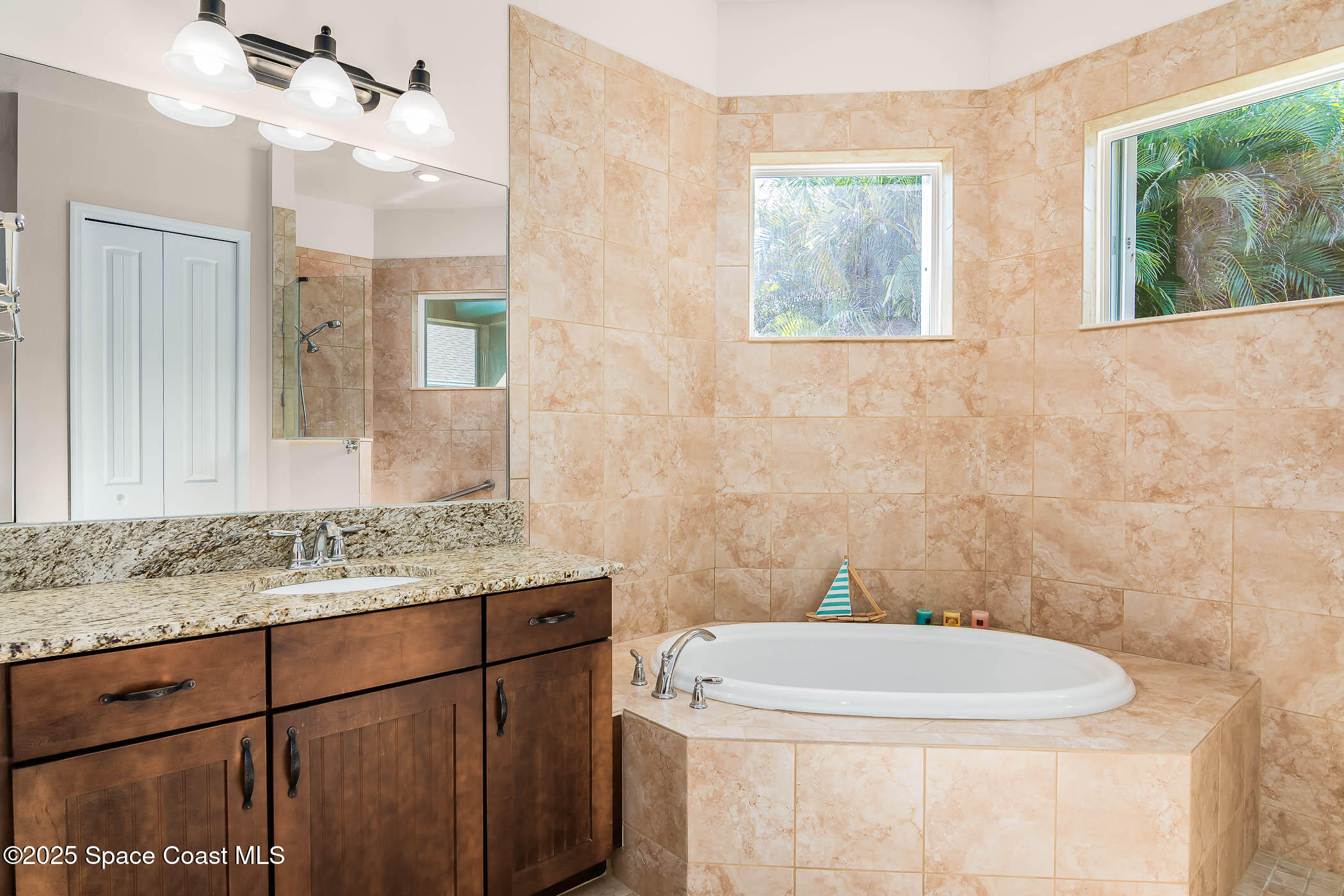 1953 Rockledge Drive Rockledge, FL 32955 - Photo 25 of 83 a bathroom with a granite countertop sink a mirror and a toilet