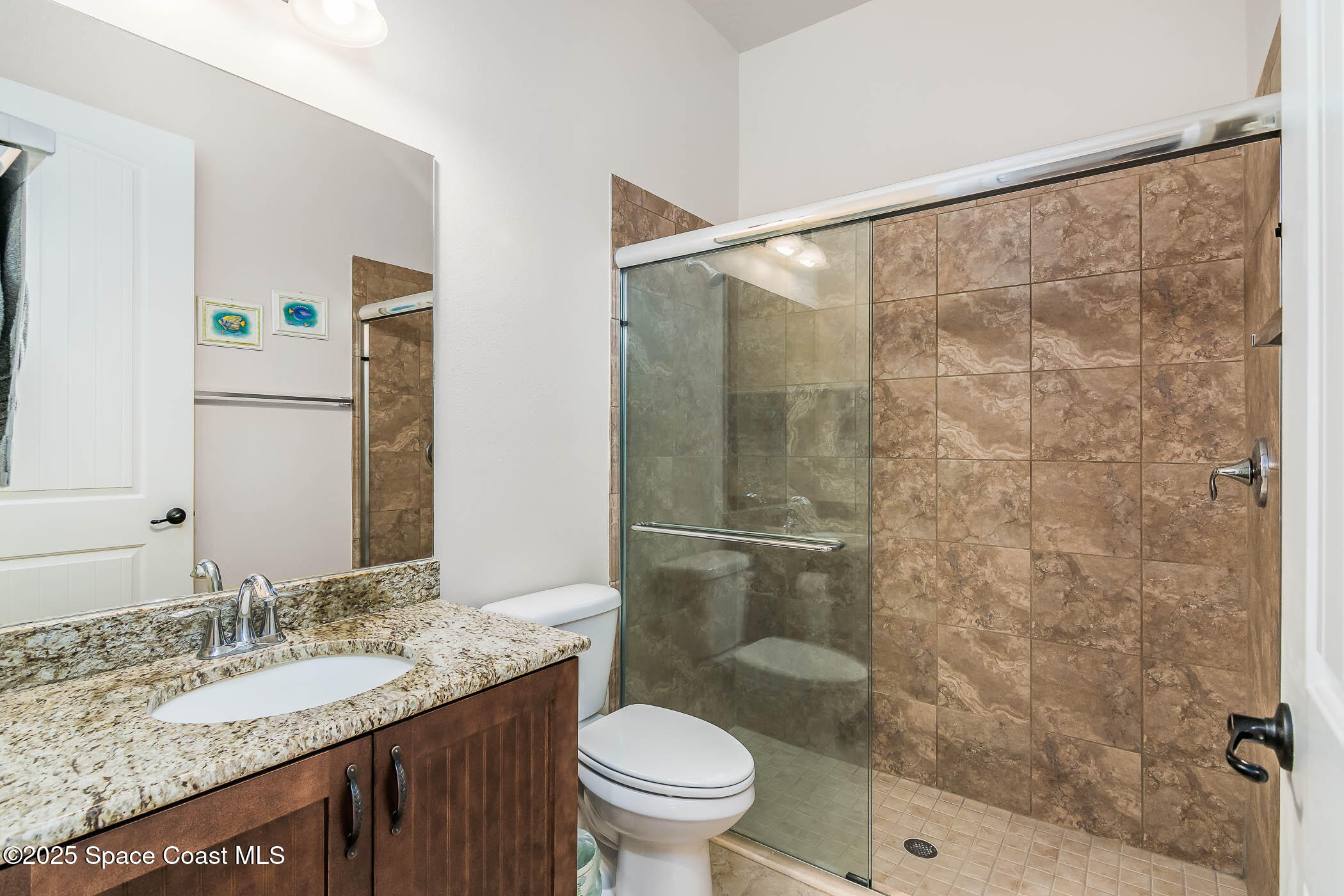 1953 Rockledge Drive Rockledge, FL 32955 - Photo 29 of 83 a bathroom with a granite countertop sink toilet and shower