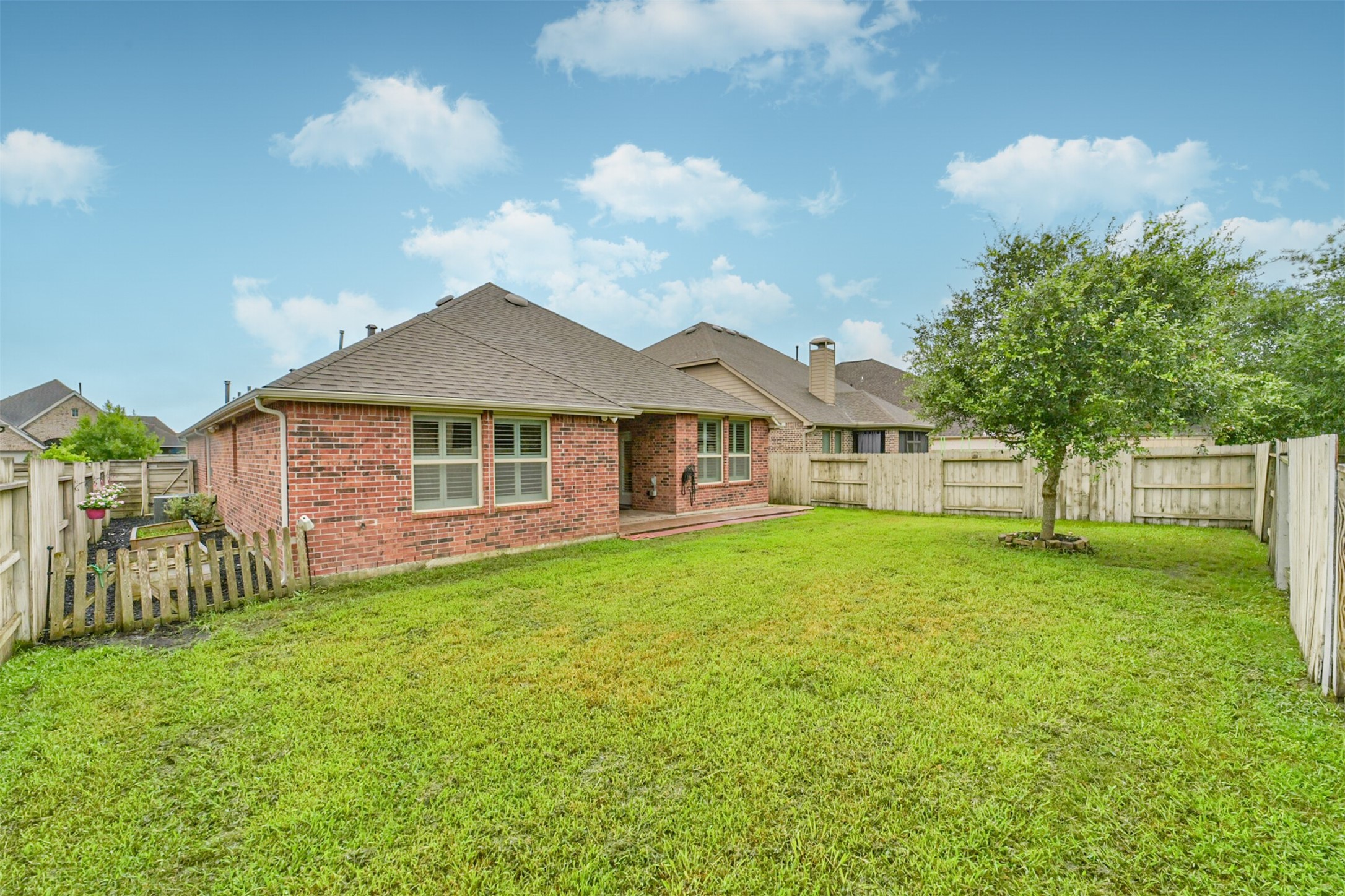2309 Redwood Ridge Trail Manvel, TX 77578 - Photo 24 of 26 Backyard with covered back patio and adorable side garden area