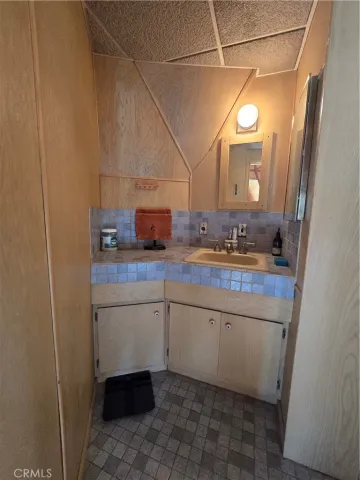 a bathroom with a sink and mirror