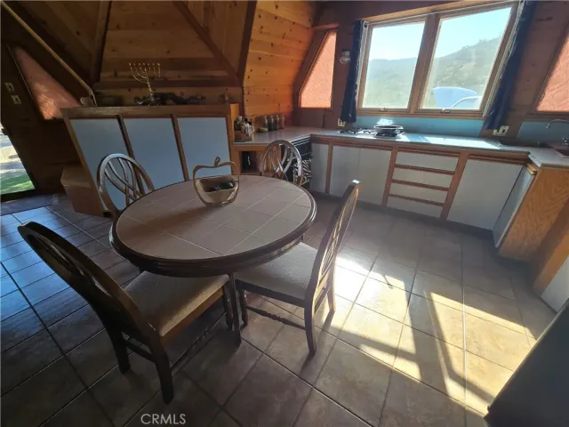 a dining room with furniture and a window