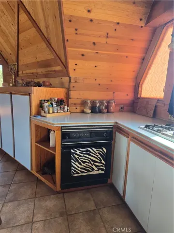 a stove top oven sitting inside of a kitchen