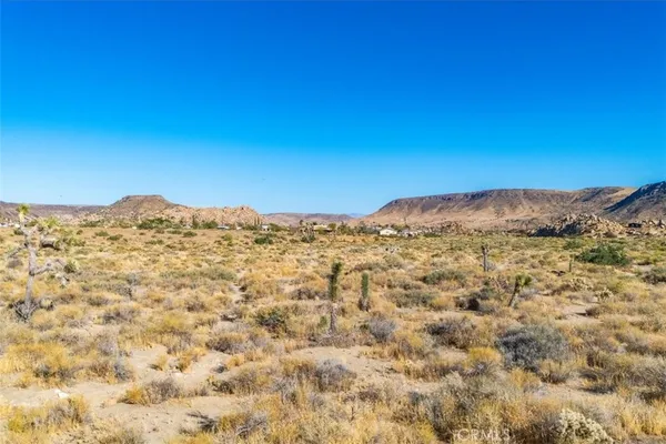 a view of a large mountain with mountains in the background
