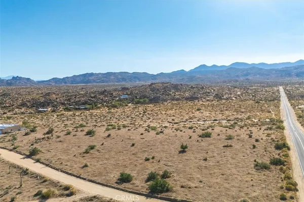 a view of a large mountain with a mountain in the background