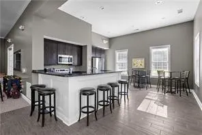 a dinning area with chairs and kitchen view