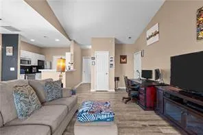 a living room with furniture and a flat screen tv