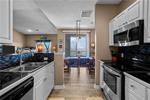 409 Stockton Ridge Cranberry Township, PA 16066 - Photo 7 of 19 a kitchen with stainless steel appliances kitchen island granite countertop a stove and a sink