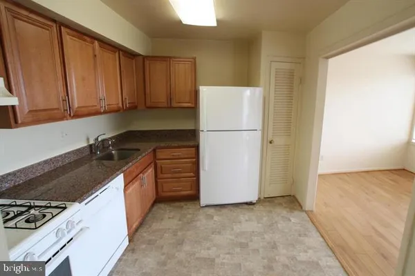 a kitchen with a refrigerator stove and cabinets
